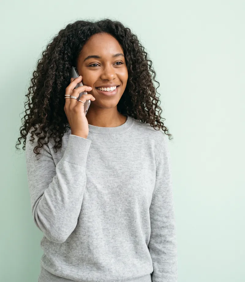 A smiling woman talking on her phone